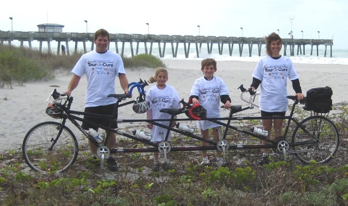 Family with their bicycle built for 4 people in Florida