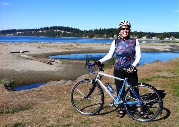 Woman touring on beach with Rodriguez Rainier road bicycle