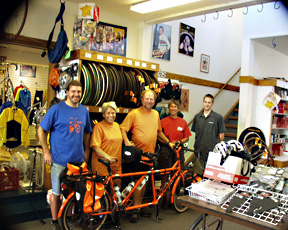 Charlie and Rose Ann with their tandem and the staff at R+E Cycles